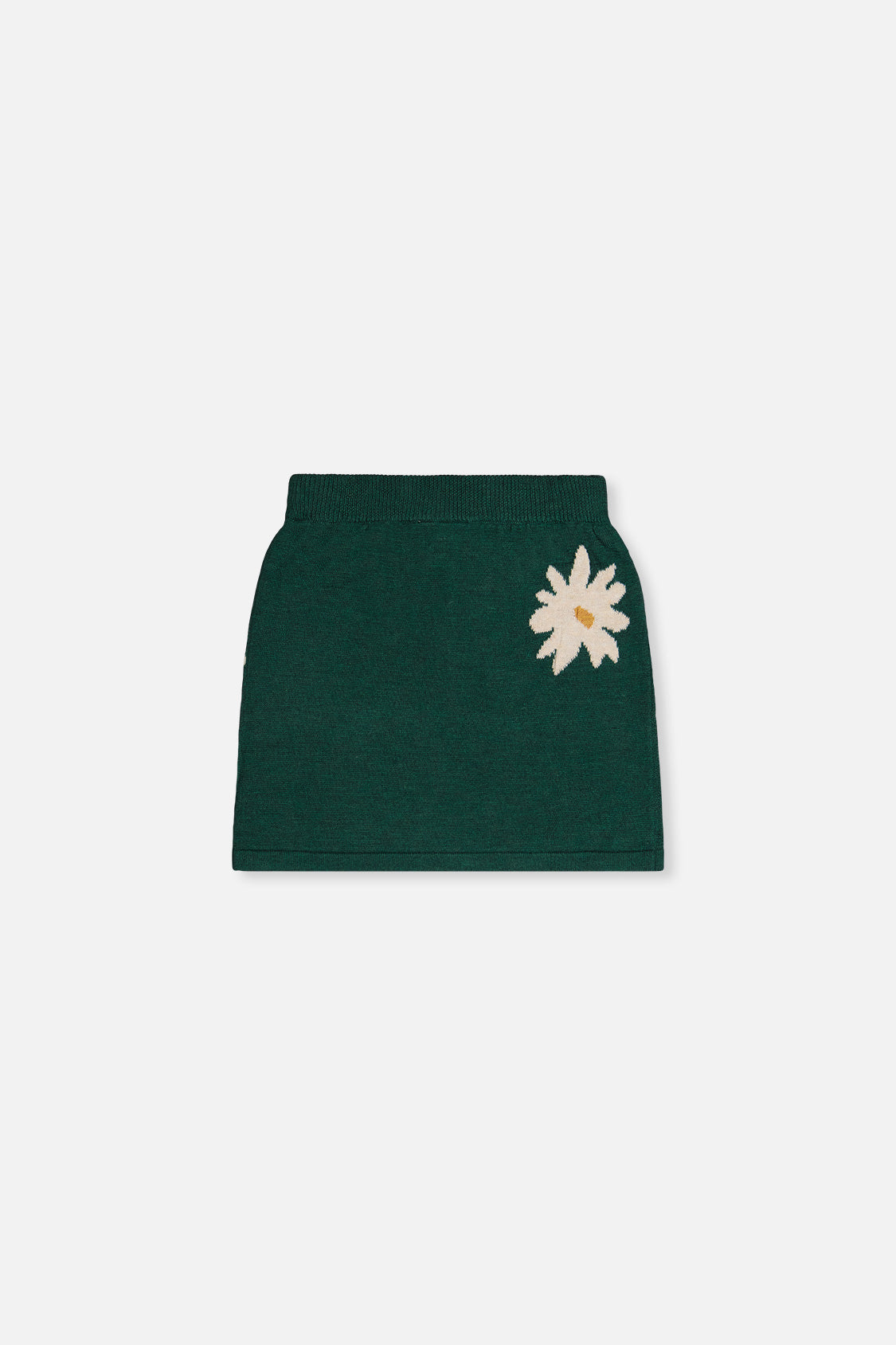 Back view of the green knitted skirt laid flat with a single daisy on one side