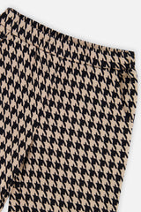 Close-up of the black and beige houndstooth pattern and elastic waist on flare pants