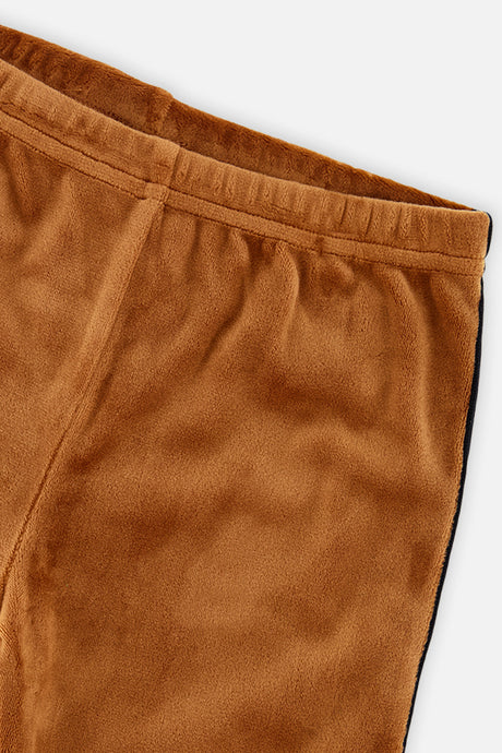 Close-up of the velvet fabric and elastic waistband on the Deux par Deux caramel leggings