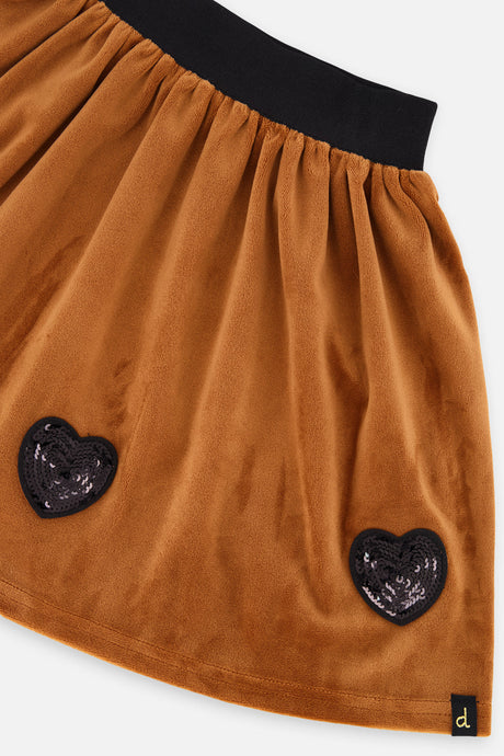 Close-up of two black sequin heart appliqués on the brown shimmer velvet