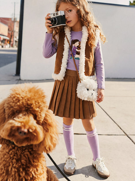 Girl with a camera and a poodle, wearing the brown pleated skirt with lavender knee socks outdoors