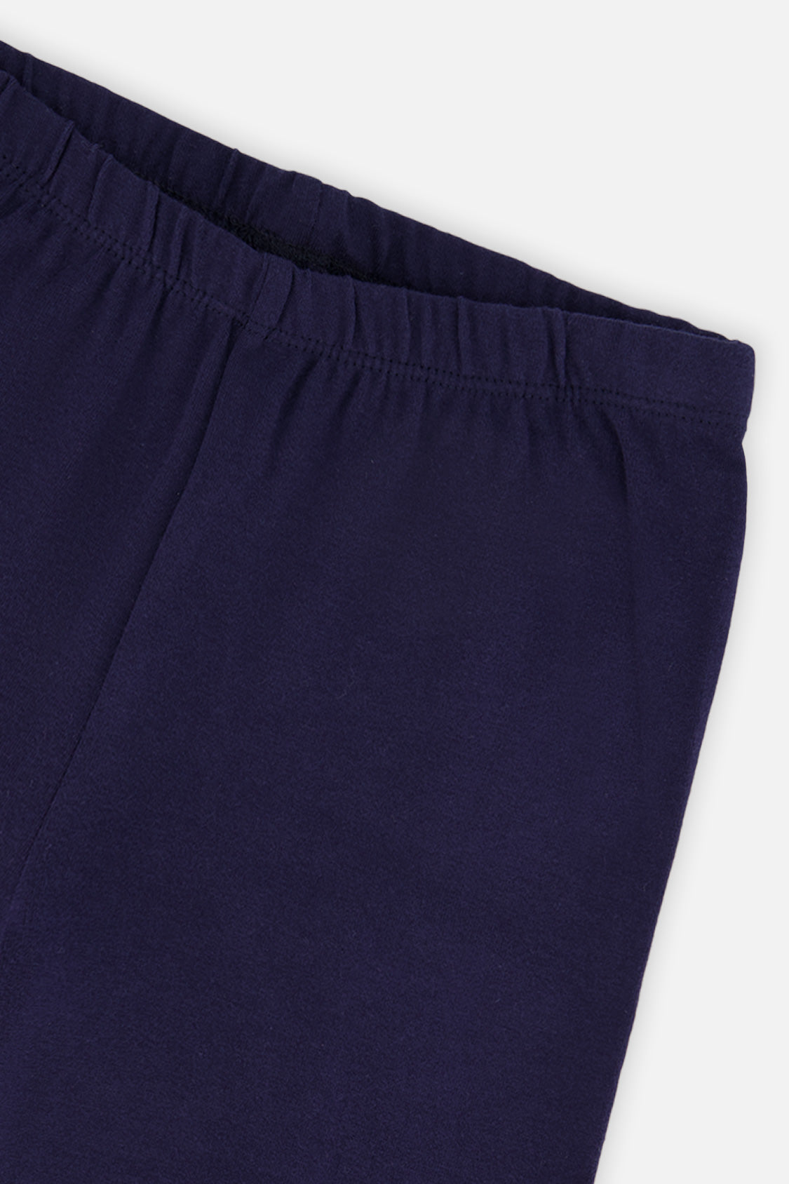 Close-up of the elastic waistband on dark blue leggings