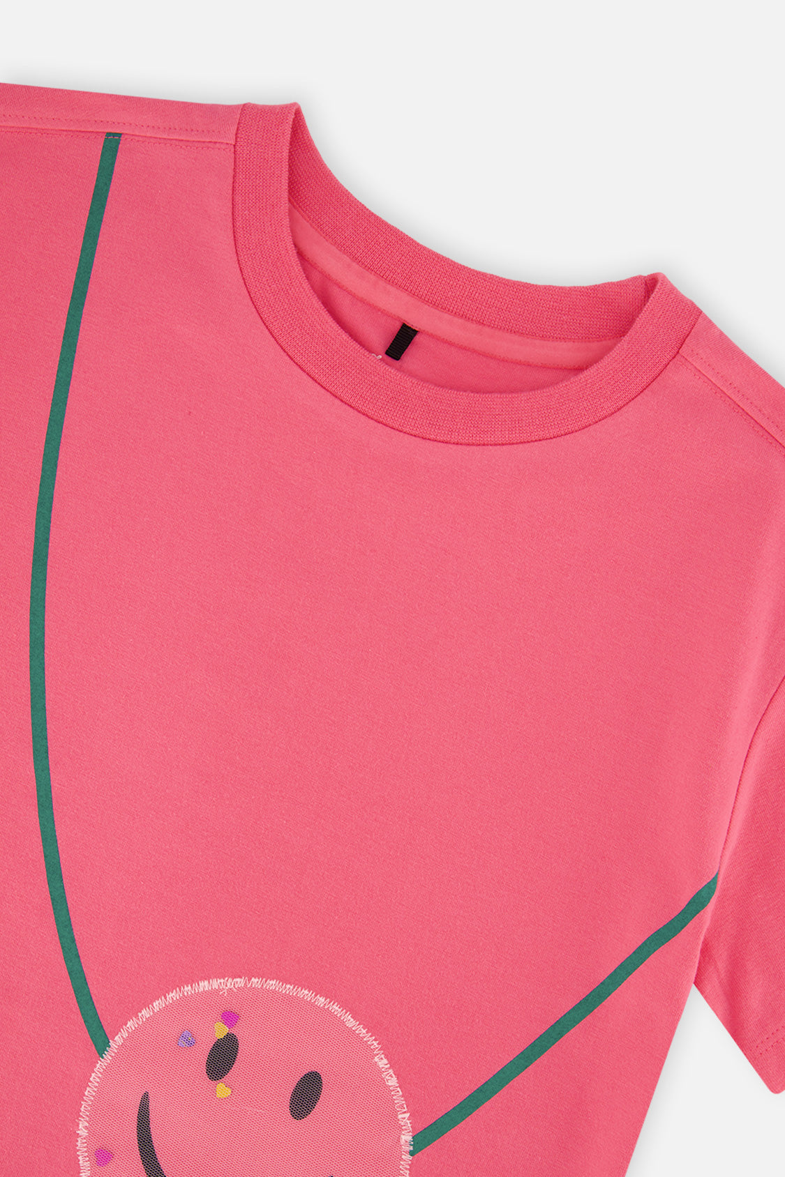Close-up of the crew neckline and sequin smiley pouch on the pink jersey