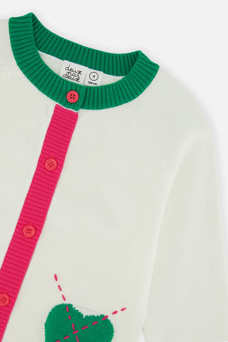 Close-up of the green ribbed neckline and the pink buttons and a green heart on the off-white Deux par Deux cardigan