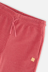 Close-up detail of the Deux par Deux raspberry pink velour flare pants