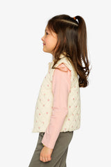Child wearing the cream floral quilted Deux par Deux vest, side view