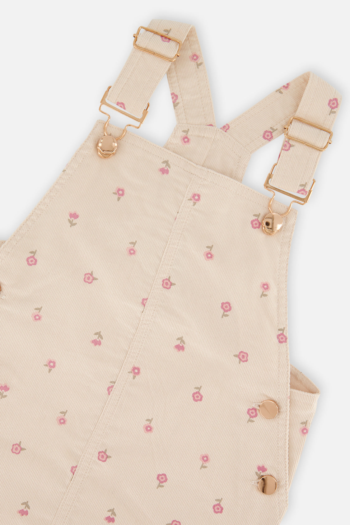 Close-up of the buckled straps and pink flower print on the Deux par Deux corduroy overall dress