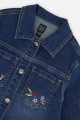 Close-up of the collar, button front and embroidered chest pocket on the blue denim jacket