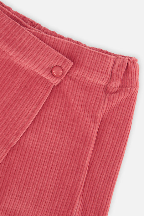 Close-up of the wrap front button and wide-wale corduroy on the raspberry pink skort