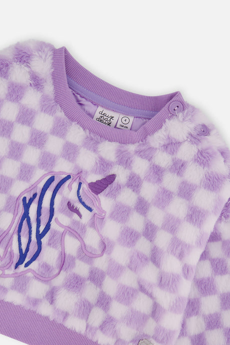 Close-up of the embroidered unicorn and the shoulder buttons and ribbed neckline on the lilac faux fur top