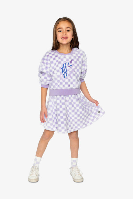Child wearing the lilac and white checkered skirt with the matching top, full-length front view