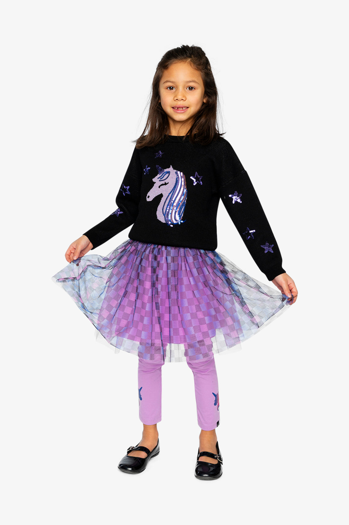 Child spreading the checkered mesh skirt wide, full-length front view