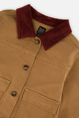 Close-up of the wine-red ribbed collar, buttons and pockets on the brown and yellow barn jacket