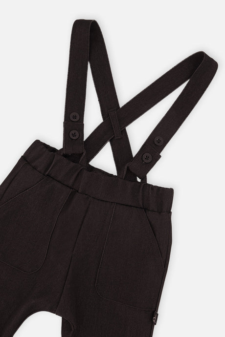 Close-up of the button suspender straps and elastic waist on the Deux par Deux baby pants