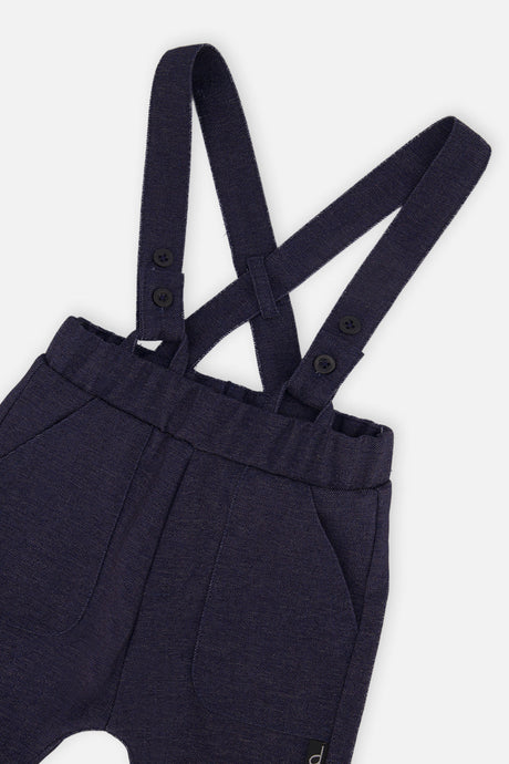 Close-up of the buttoned suspender straps and pocket on the Deux par Deux navy baby pants