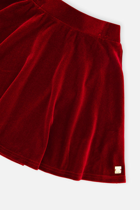 Close-up of the red velvet folds and small gold logo tab