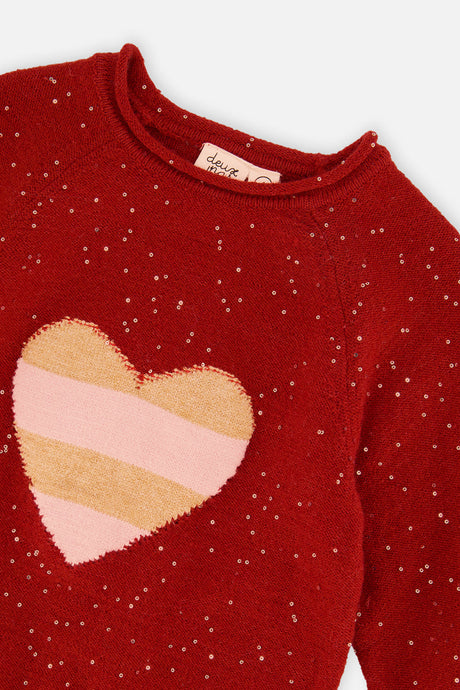 Close-up of the striped pink and gold heart and gold flecks on the red Deux par Deux sweater