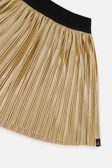 Close-up of the black elastic waistband and fine accordion pleats on the gold skirt