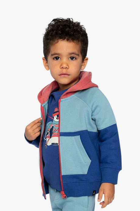 Child wearing the blue color-block fleece jacket open with a hand on the zipper, three-quarter view