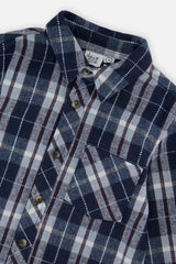 Close-up of the collar, buttons and chest patch pocket on the blue and white plaid flannel shirt