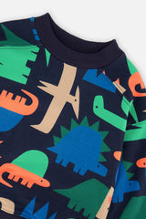 Close-up of the crew neckline and dinosaur print on the blue fleece sweatshirt