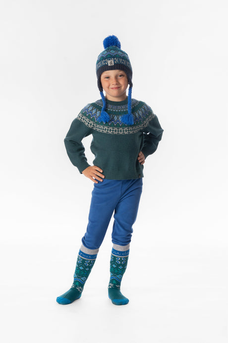 Boy wearing the blue thermal underwear leggings with a Fair Isle sweater and earflap knit hat, front view