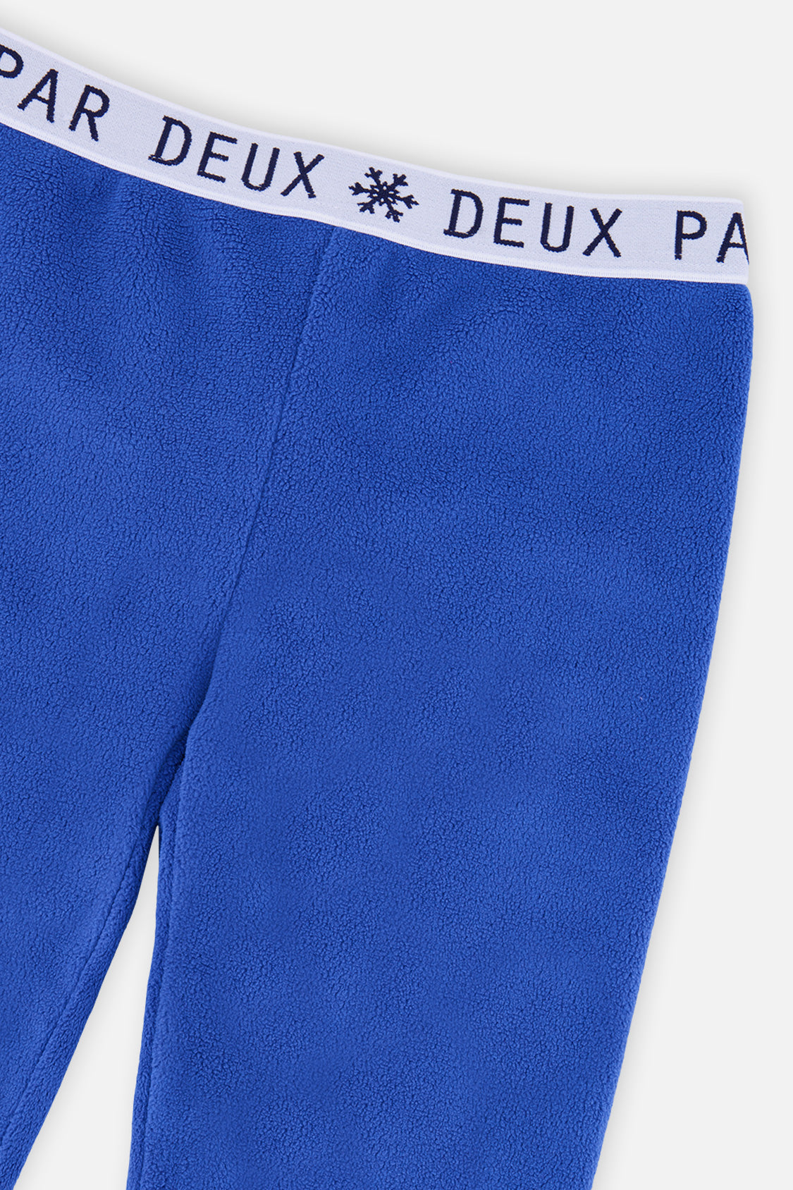 Close-up of the snowflake logo waistband on the blue thermal underwear leggings