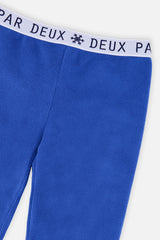 Close-up of the snowflake logo waistband on the blue thermal underwear leggings
