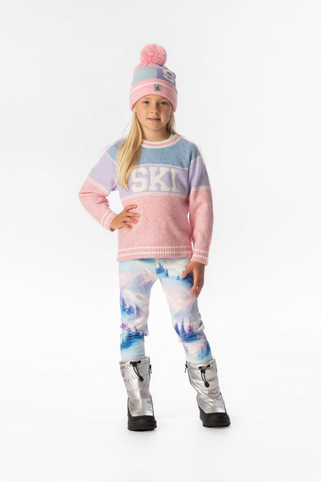Child wearing the blue lilac and pink ski sweater with a pompom beanie and printed leggings, front view