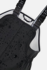 Water droplets beading on the black polyurethane bib of the Deux par Deux rain overalls