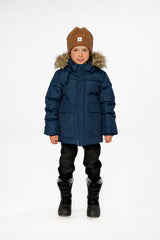 Child wearing the Deux par Deux dark blue winter jacket with faux-fur hood, view 1