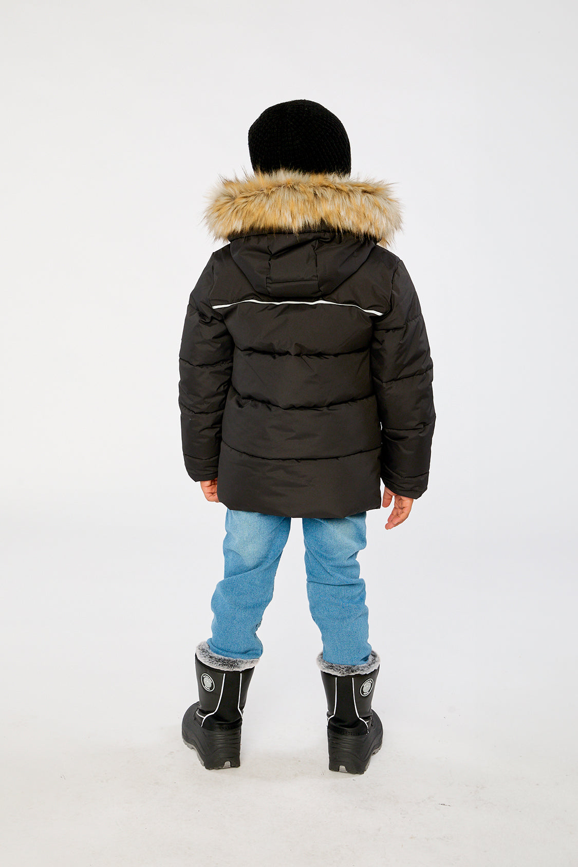 Child wearing the Deux par Deux black winter jacket with faux-fur hood, view 3
