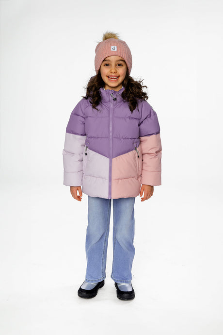Child wearing the violet, lilac and peach color-block winter jacket with a pink pom-pom hat and jeans
