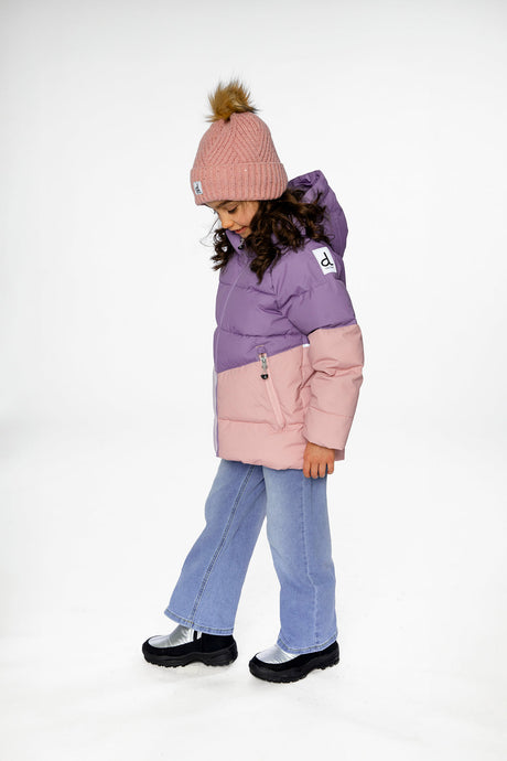 Side view of a child looking down in the violet color-block jacket and wide leg jeans