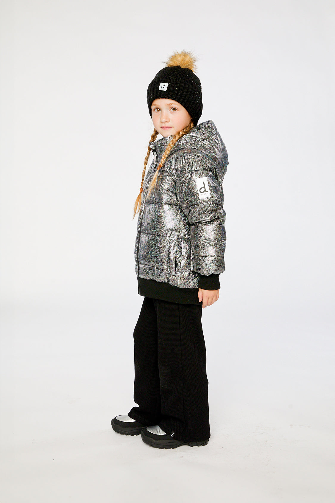 Child wearing the Deux par Deux dark metallic glitter puffy winter jacket, side view