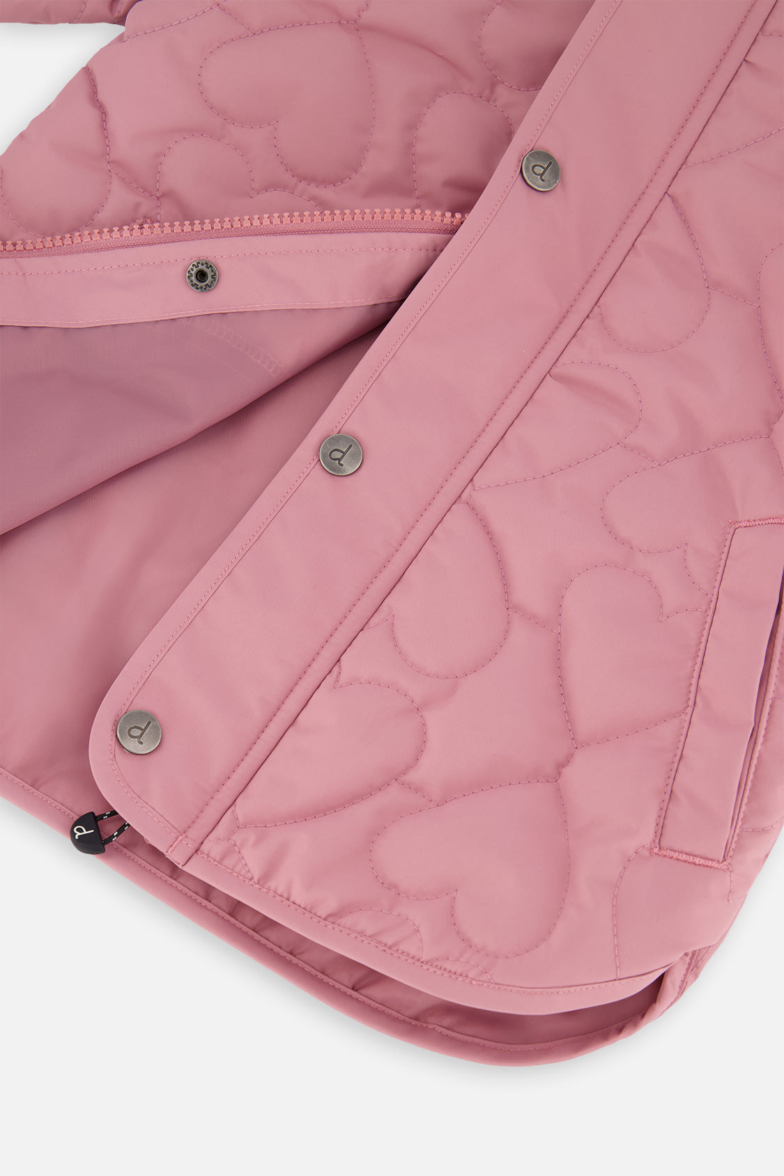 Close-up of the snap placket opened to show the smooth pink lining and a side pocket