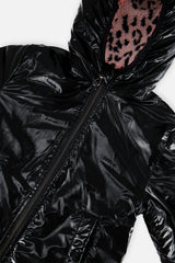 Close-up of the glossy black side and the sherpa-lined hood opening of the reversible jacket