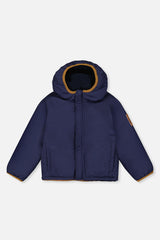 Smooth dark blue coated side of the reversible jacket laid flat, front view
