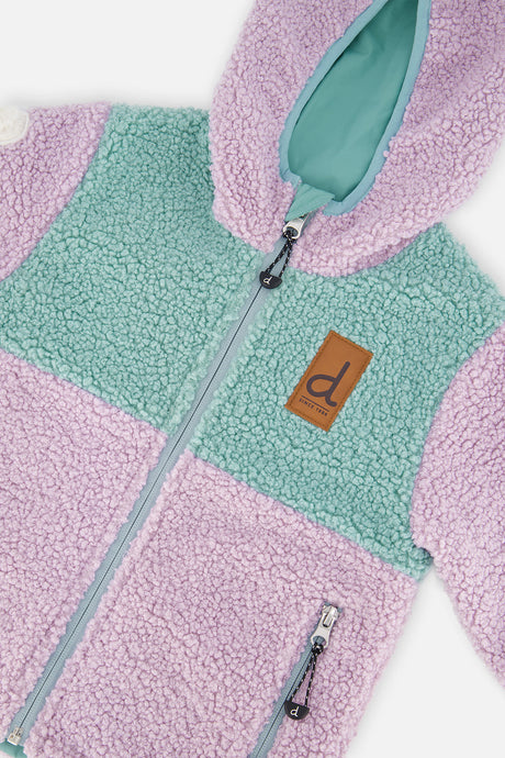 Close-up of the sherpa front, zipper and brown tag on the Deux par Deux reversible jacket