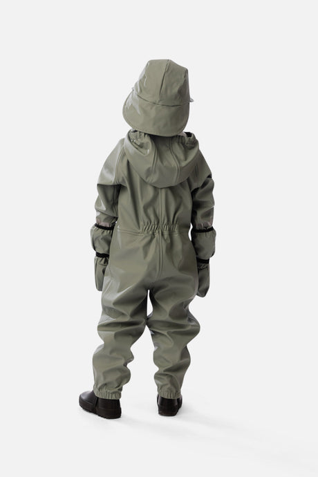 Back view of a child wearing the sage green rain one-piece with mittens and a rain hat