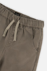 Close-up of the elastic waist, drawcord and pocket on grey twill cargo pants