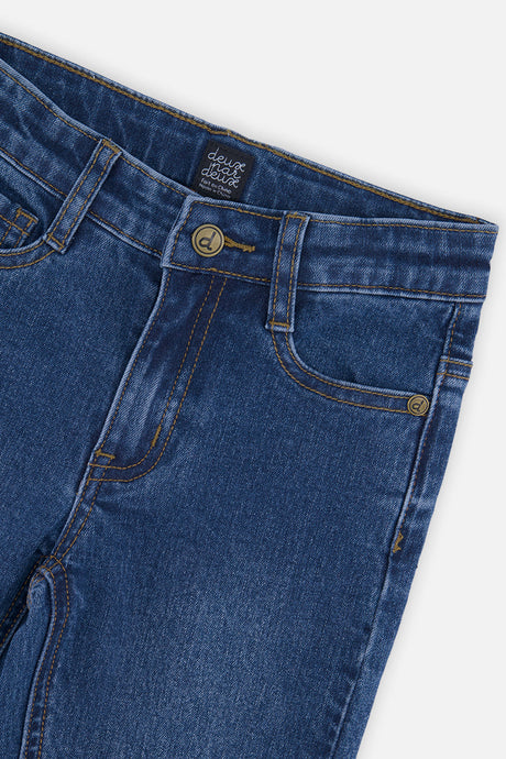 Close-up of the waistband, button and five-pocket layout on navy blue stretch jeans