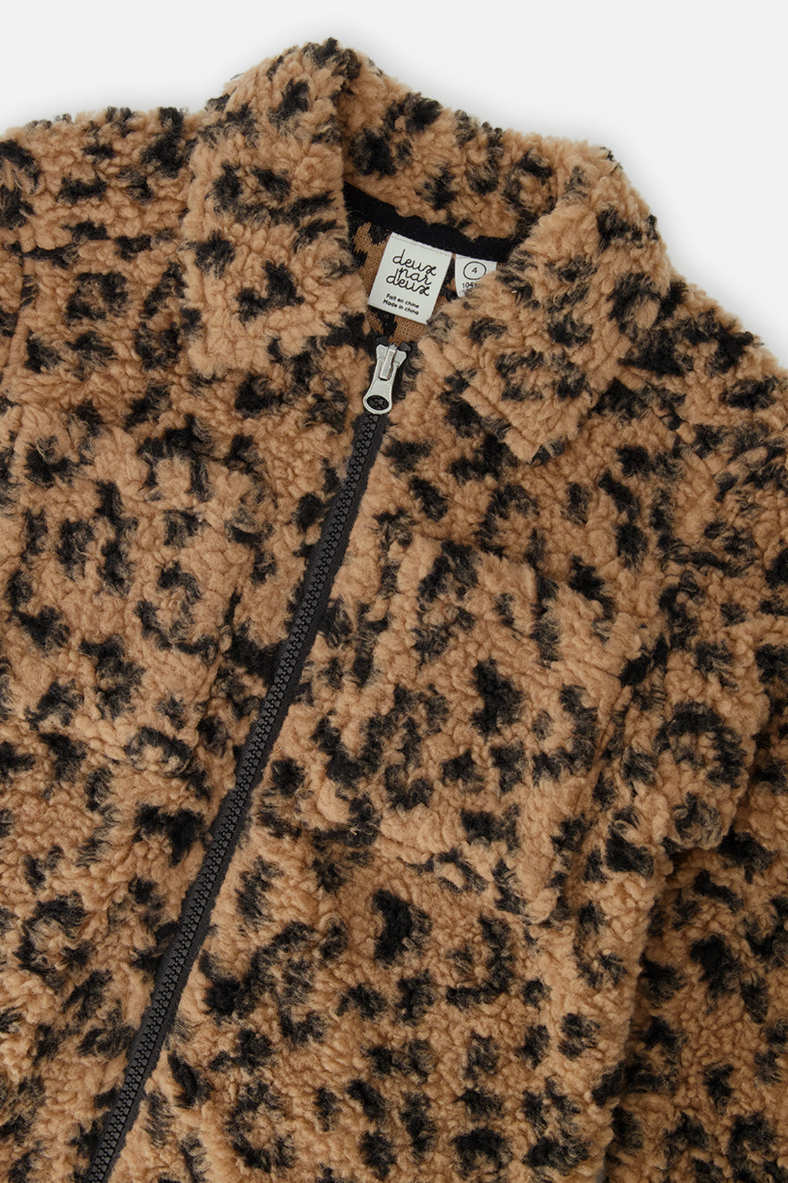 Close-up of the plush leopard sherpa collar and front zip on the overshirt