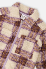 Close-up of the looped sherpa plaid collar and chest pocket on the overshirt