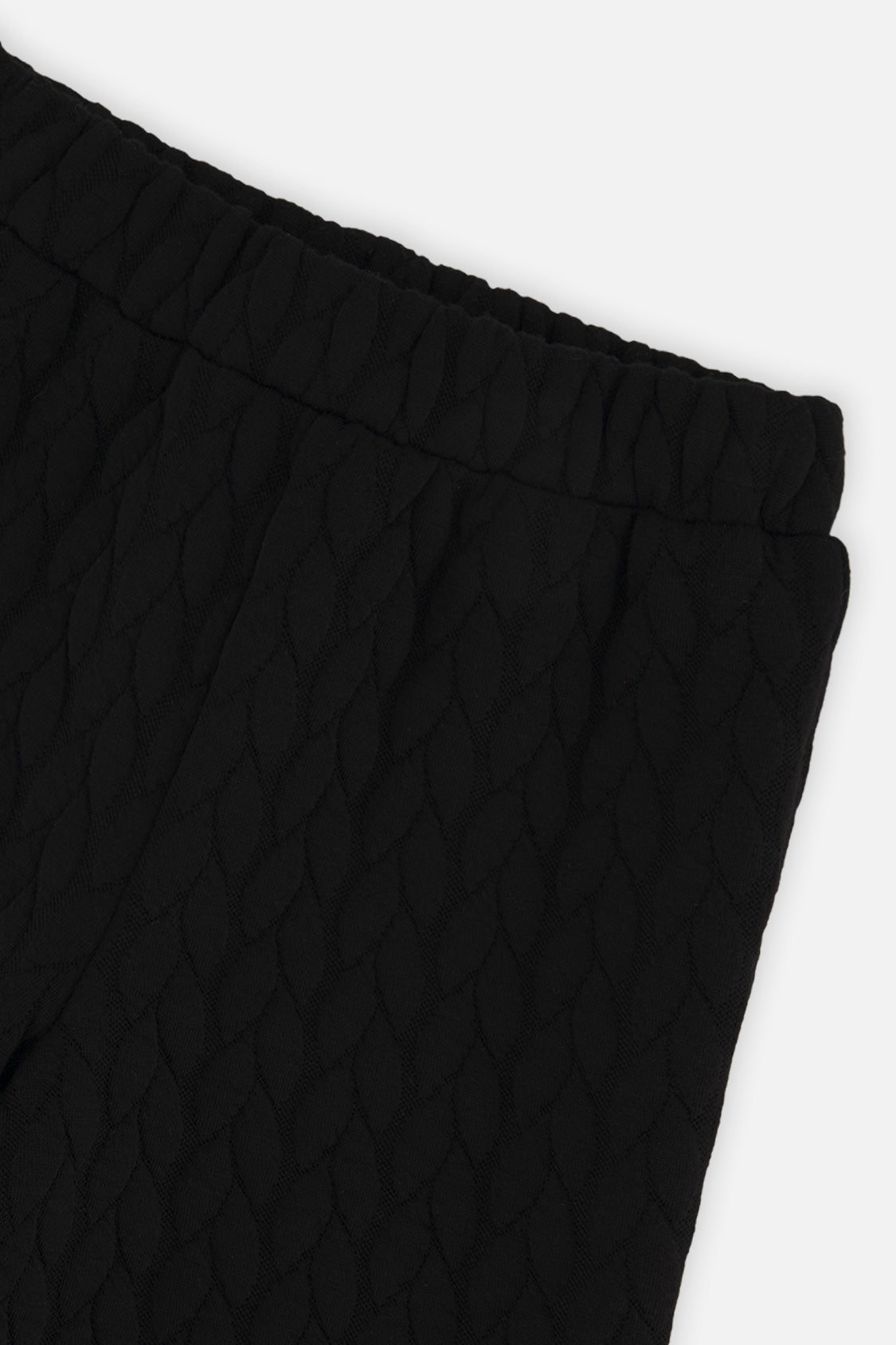 Close-up of the Wide Leg Jacquard Pants Black quilted fabric and elastic waist