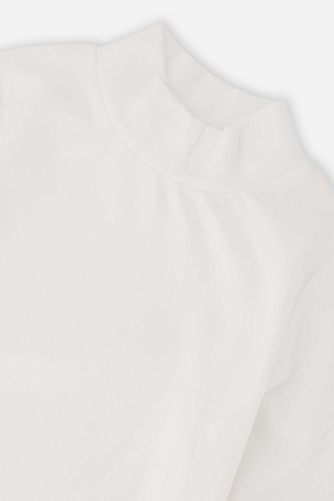 Close-up of the ribbed mock neck collar on the off-white top