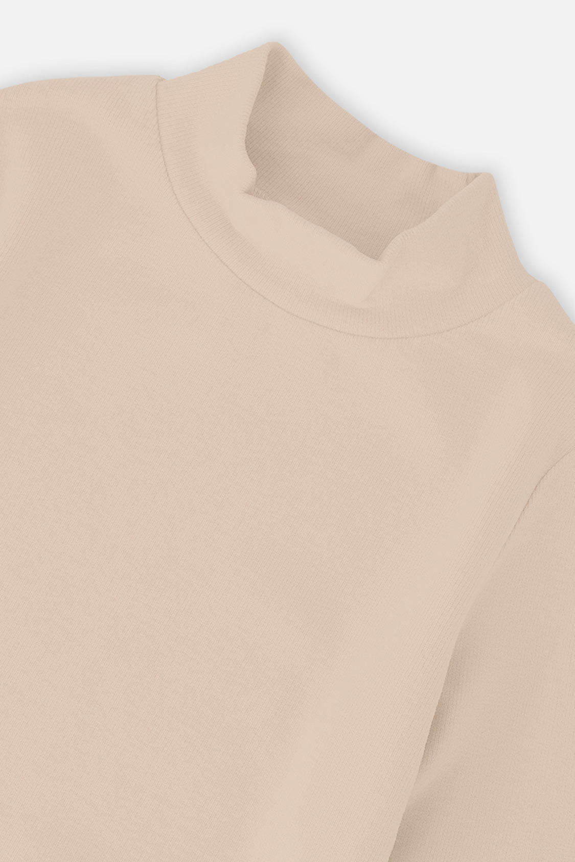 Close-up of the mock neck and brushed rib knit on the beige top