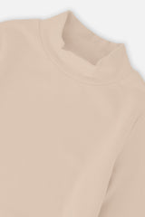 Close-up of the mock neck and brushed rib knit on the beige top
