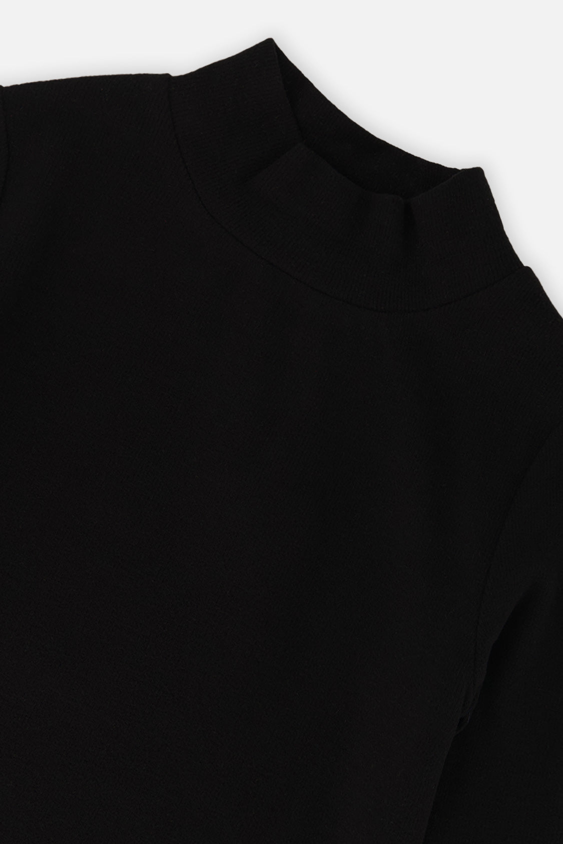 Close-up of the ribbed mock neck collar on the black top