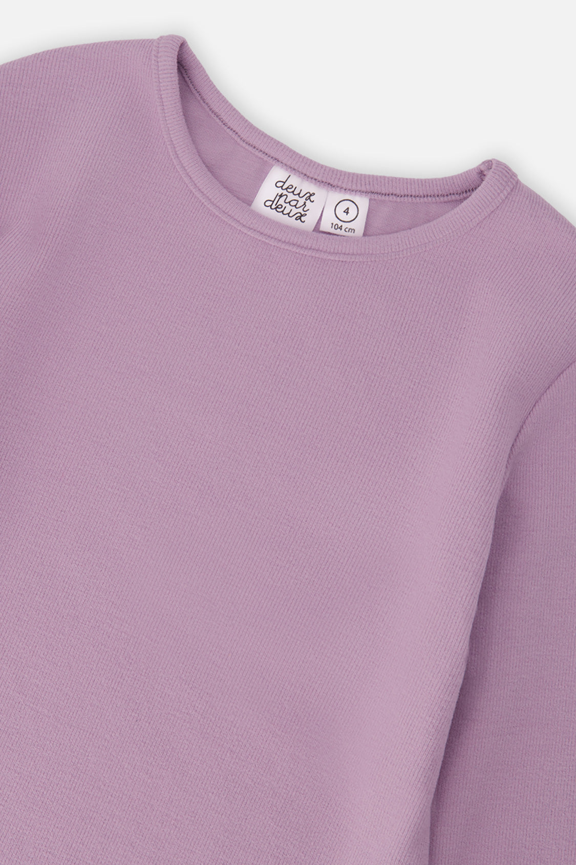 Close-up of the crew neckline and vertical rib on the violet top
